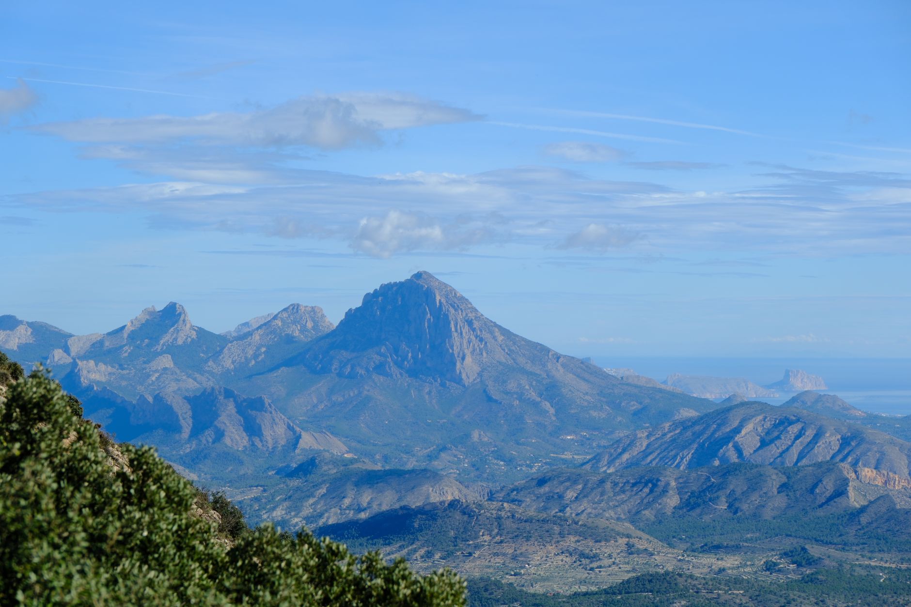 Rugged Spanish mountain terrain with rocky ridges and forest, typical of hunting ground in Spain