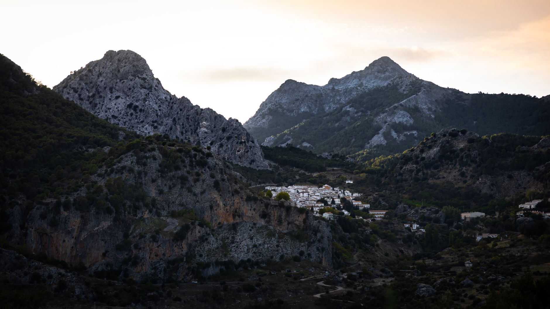 A winding road through a Spanish mountain landscape at sunrise