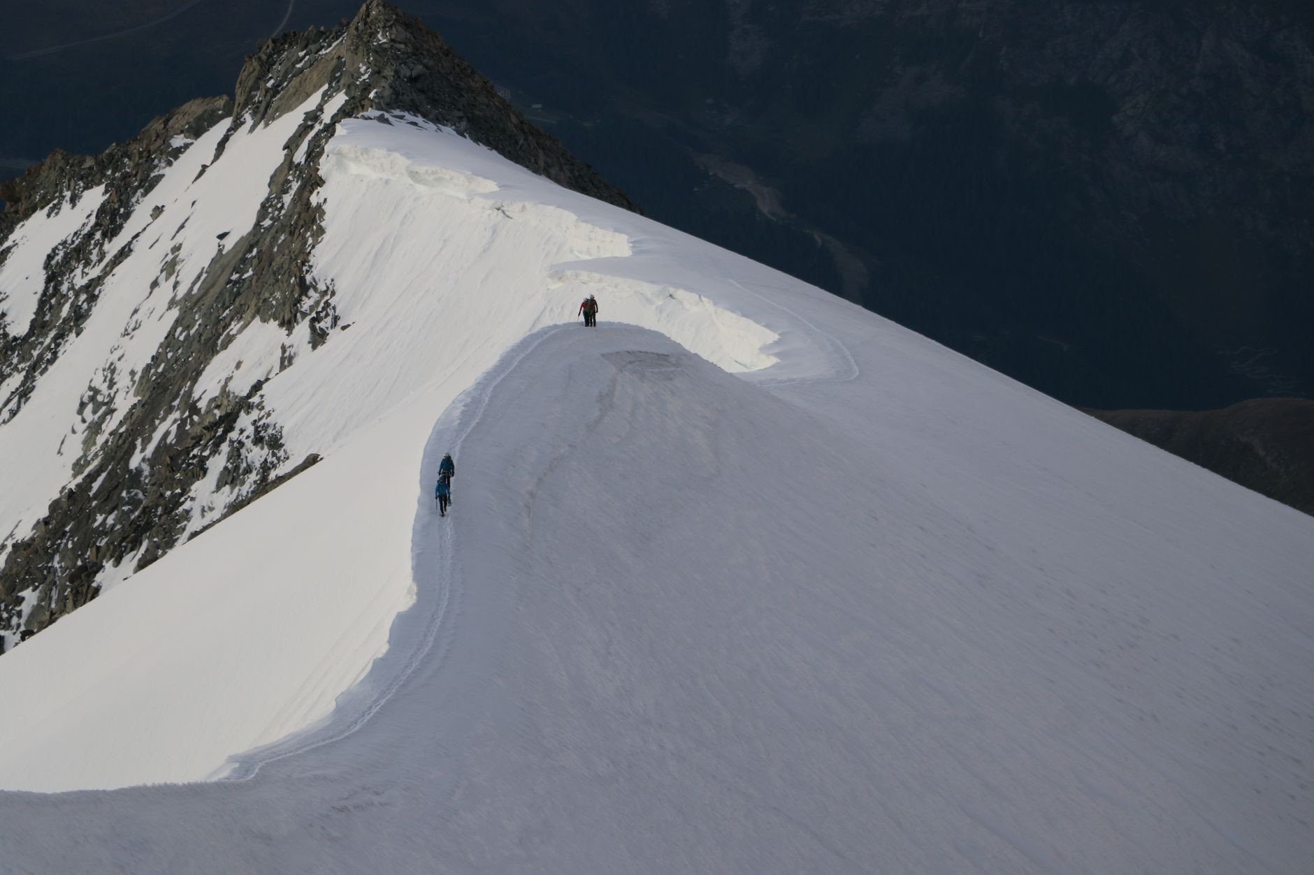 A guide and hunter moving carefully along a high mountain ridge in Spain